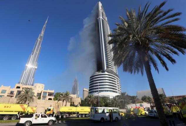 Plumes of smoke rise from the 63-storey Address Downtown Dubai hotel and residential block near the Burj Khalifa in Dubai